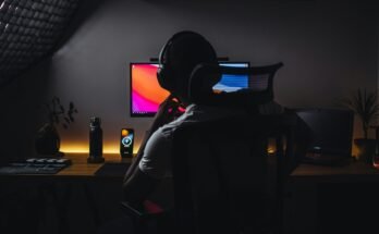 Young Man Watching Tutorial with Headphones On