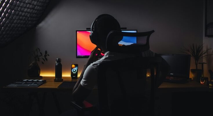 Young Man Watching Tutorial with Headphones On